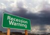 Recession Warning sign with dark clouds above