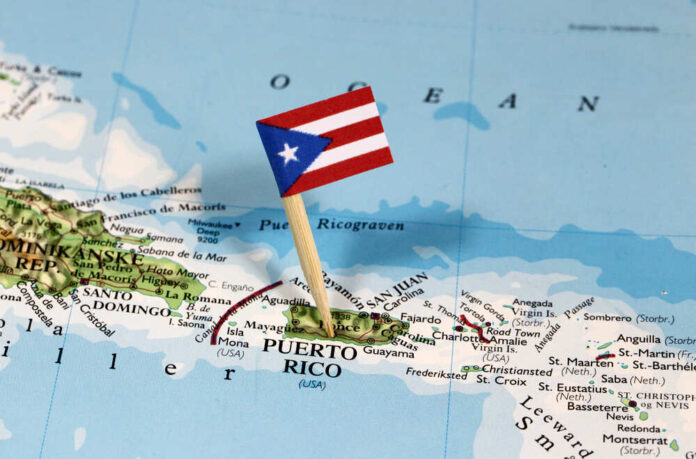 shutterstock_1051262333.jpg featured image Puerto Rico map with flag on it.