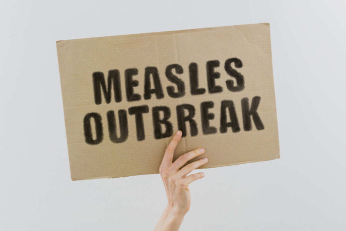 shutterstock_1609790611.jpg featured image Measles outbreak sign