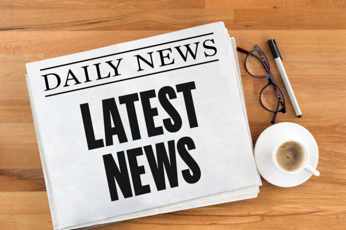 shutterstock_565653796.jpg featured image Newspaper with headline latest news on table