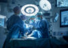 Doctors performing surgery in a modern operating room.