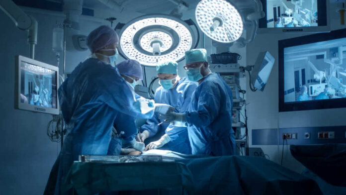 shutterstock_741434737.jpg featured image Doctors performing surgery in a modern operating room.