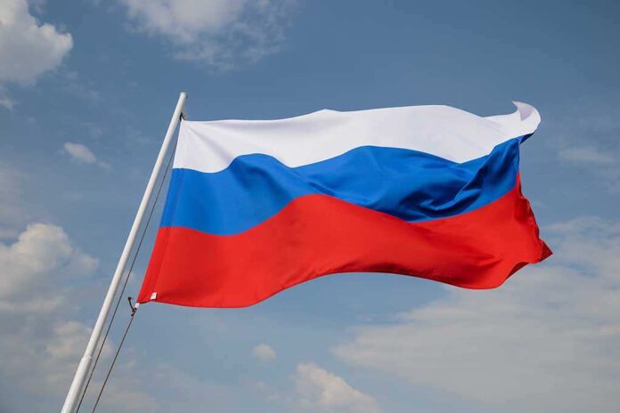 1902803902 featured image Russian flag waving against a cloudy sky.