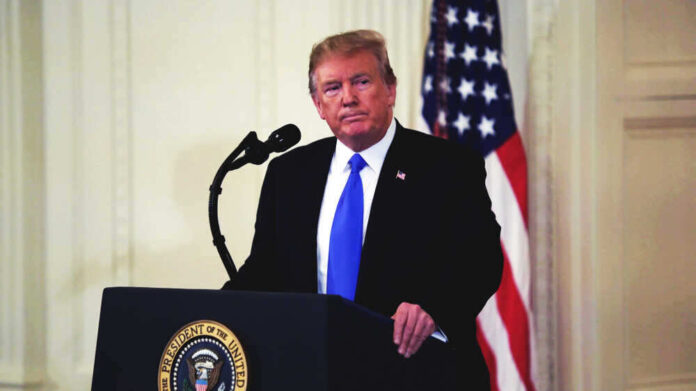 Donald Trump speaking at podium.