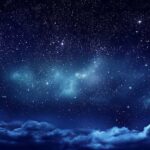 Starry night sky with clouds below