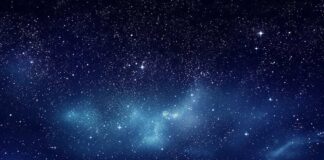 Starry night sky with clouds below