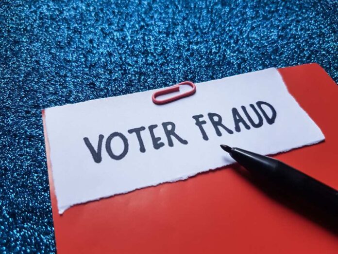 shutterstock_2534479629.jpg featured image Paperclip holding paper labeled voter fraud marker