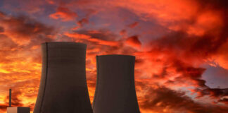 Nuclear power plant cooling towers at sunset.