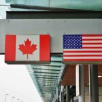 Canada Surrenders; Trump Wins Canada and U.S. flags at an airport.