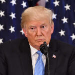 Trump DISOWNS GOP Congressman – Calls Him LOSER! Donald Trump speaking with American flags in background.