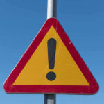 Baywatch Star’s Cause of Death Revealed Triangular warning sign with exclamation mark.