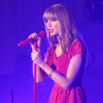 Human Remains Found Near Taylor Swift’s Home?! Taylor Swift in a red dress performing on stage.