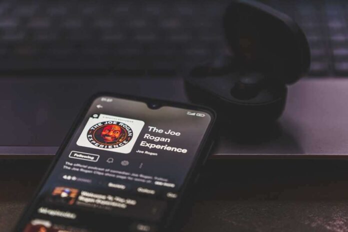 shutterstock_2125385813.jpg featured image Smartphone displaying “The Joe Rogan Experience” podcast screen.