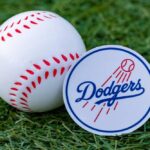 Dodgers BLOCK Federal Agents from Stadium? Baseball and Dodgers logo on grass background