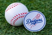 Baseball and Dodgers logo on grass background