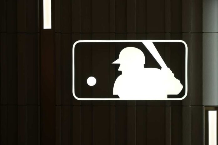 shutterstock_2271619161.jpg featured image MLB logo with a baseball player silhouette