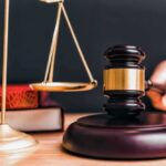 Justice SEVERELY LACKING – One Day Sentence? Judge gavel, scales of justice, and law books.