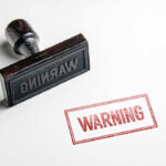 Rubber stamp with warning text imprint