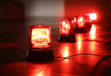 Red emergency lights on dark floor illuminating the area