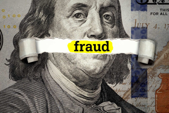 Dollar bill with fraud text overlay