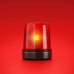 Red emergency light on solid red background