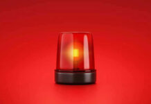 Red emergency light on solid red background