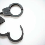 Man’s SHOCKING ICE Threats Lead To Arrest Open metal handcuffs on white background