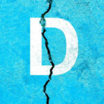 White letter D on cracked blue surface.