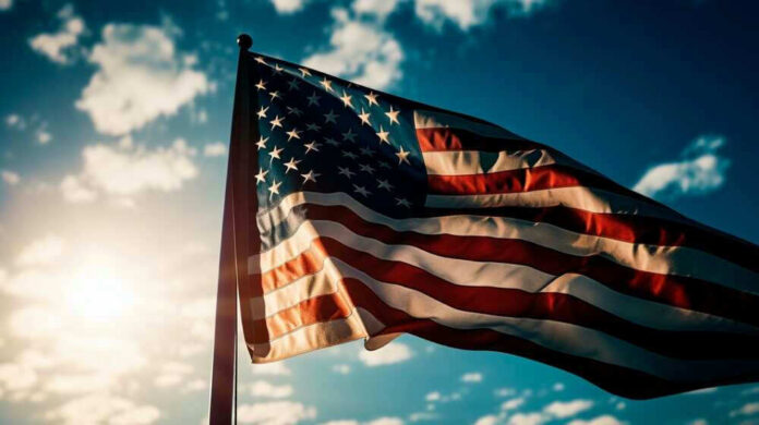 shutterstock_2298660407.jpg American flag waving against a bright sky