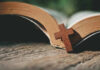 Open Bible with a wooden cross on it