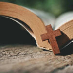 Open Bible with a wooden cross on it