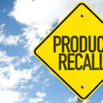 Shocking Sausage Recall—24,000 Pounds Pulled! Yellow product recall sign against cloudy sky