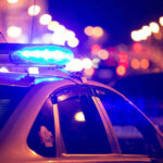 Missing Baby Haunts Americans; Cops Still Baffled Police car with blue lights flashing at night