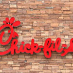 Chick-fil-A restaurant sign on a stone wall