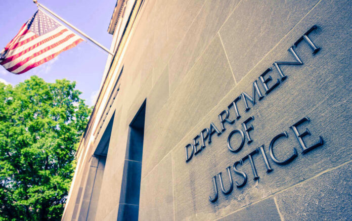 shutterstock_1384089728.jpg Department of Justice building with American flag