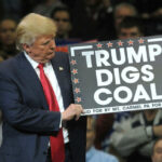 Donald Trump holding sign saying Trump Digs Coal