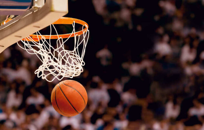 Basketball about to enter hoop during game