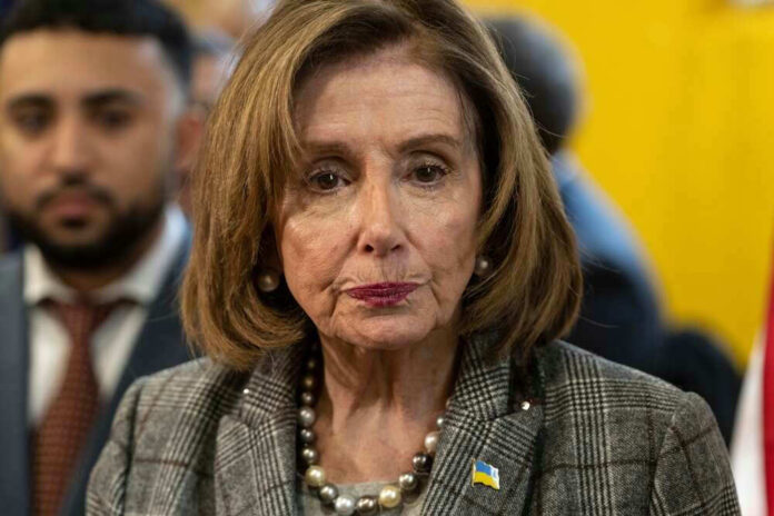 shutterstock_2135602043.jpg Nancy Pelosi wearing plaid blazer at event