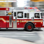 Red fire truck driving on city street