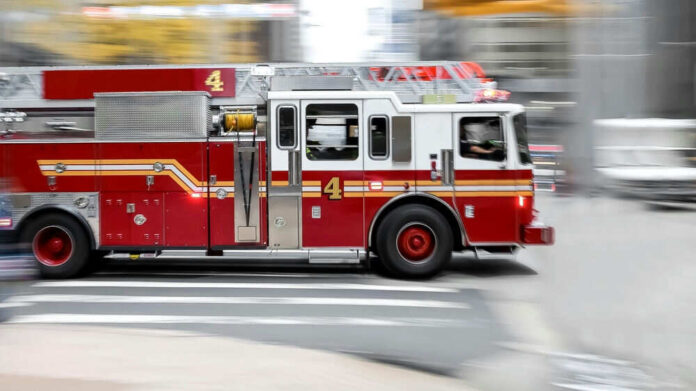 Red fire truck driving on city street