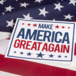 Sign saying Make America Great Again on American flag