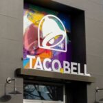 Exterior view of a Taco Bell restaurant with colorful mural