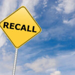 Deadly Listeria Hits Frozen Veggies – Recall Alert! Yellow sign with RECALL text against blue sky