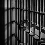 Rusty prison bars in dim lighting