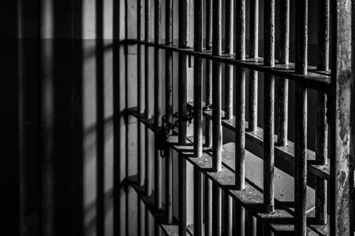 Rusty prison bars in dim lighting