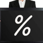 TrumpRx Platform LAUNCHES: Major 50% SAVINGS Man holding blackboard with white percent symbol