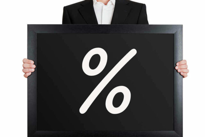 Man holding blackboard with white percent symbol