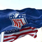 NFL flag waving in front of American flag