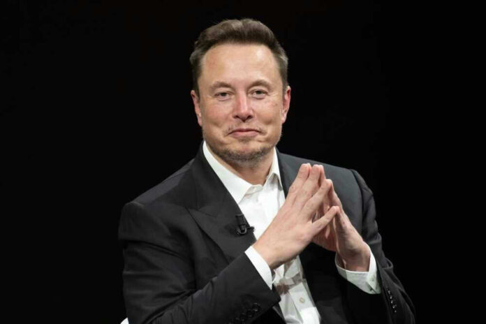 Elon Musk in a suit talking.