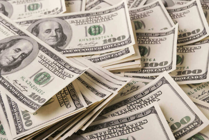 Stacks of one hundred dollar bills scattered.